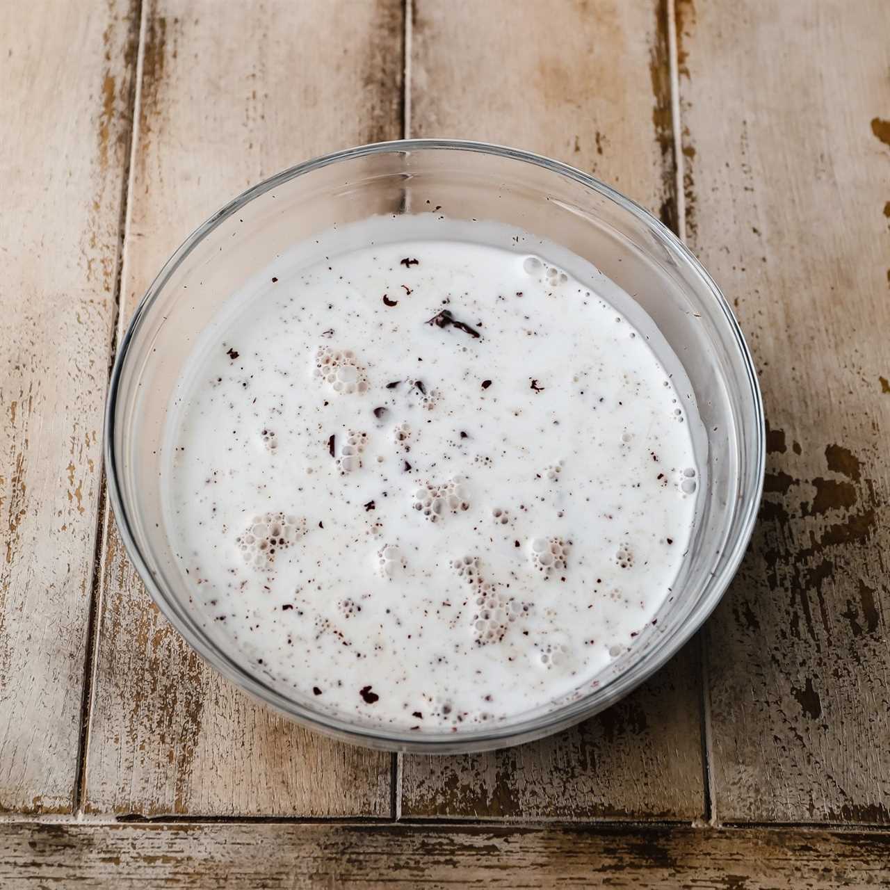 coconut milk and chopped chocolate in a glass bowl.