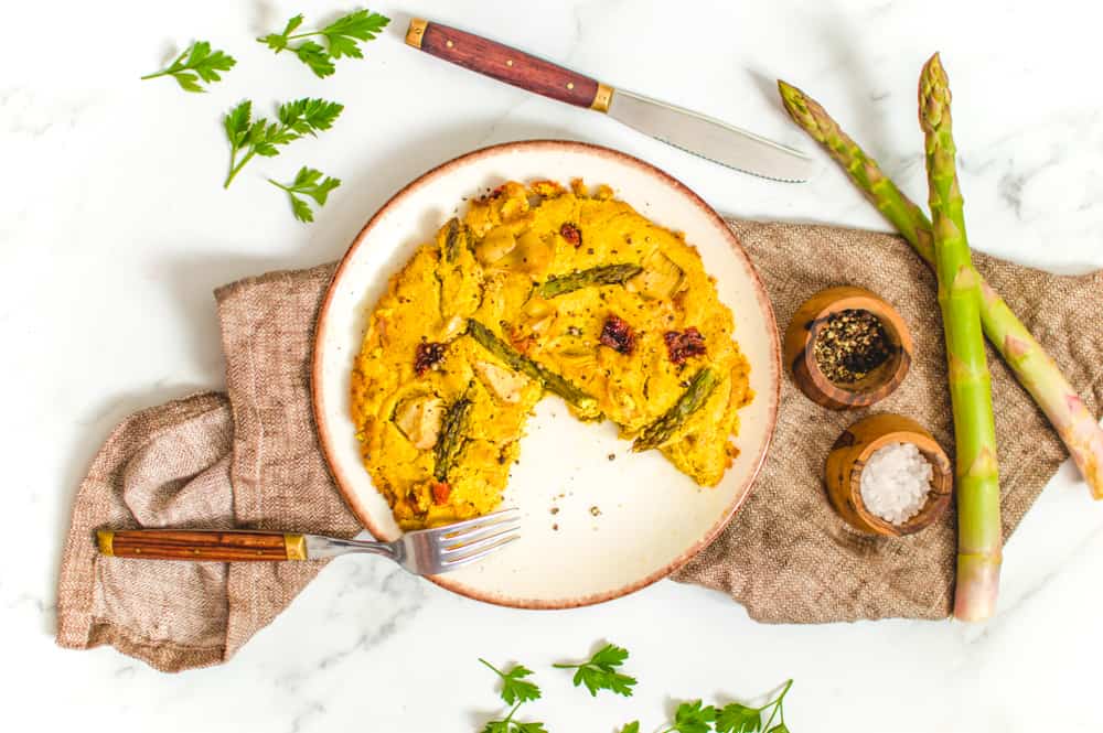 vegan tofu frittata with asparagus served on a rustic plate for easter