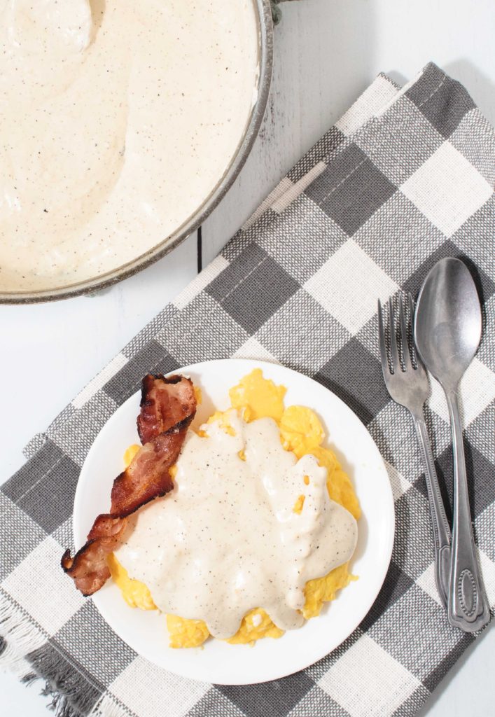 Low carb white gravy on top of scrambled eggs with crispy bacon.