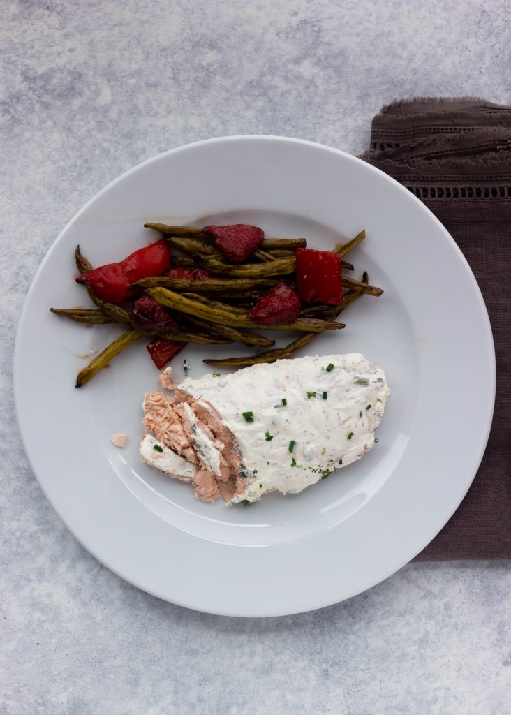 Easy keto salmon with fresh herbs and roasted summer vegetables. 