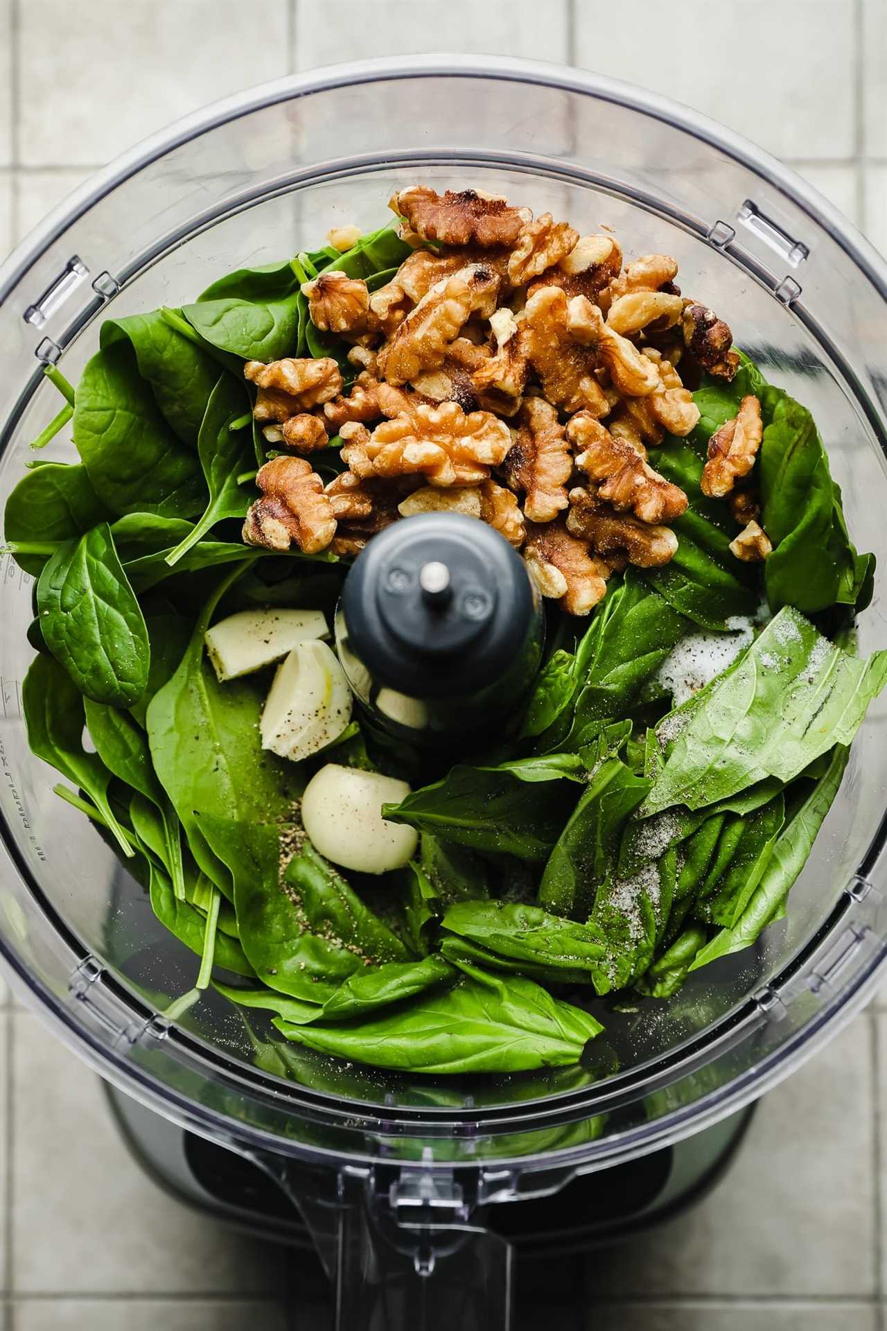 ingredients for spinach pesto in a food processor.