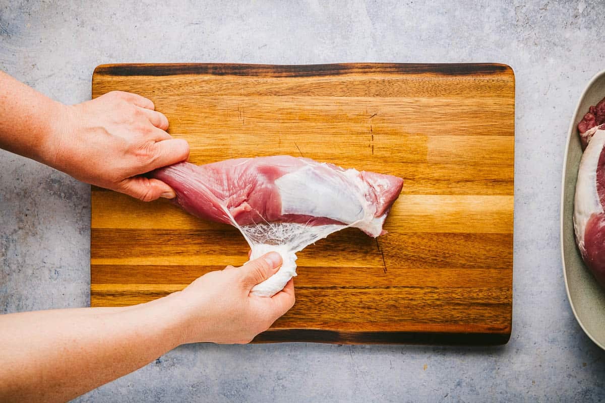 Removing the silver skin from pork tenderloin to make pork souvlaki.