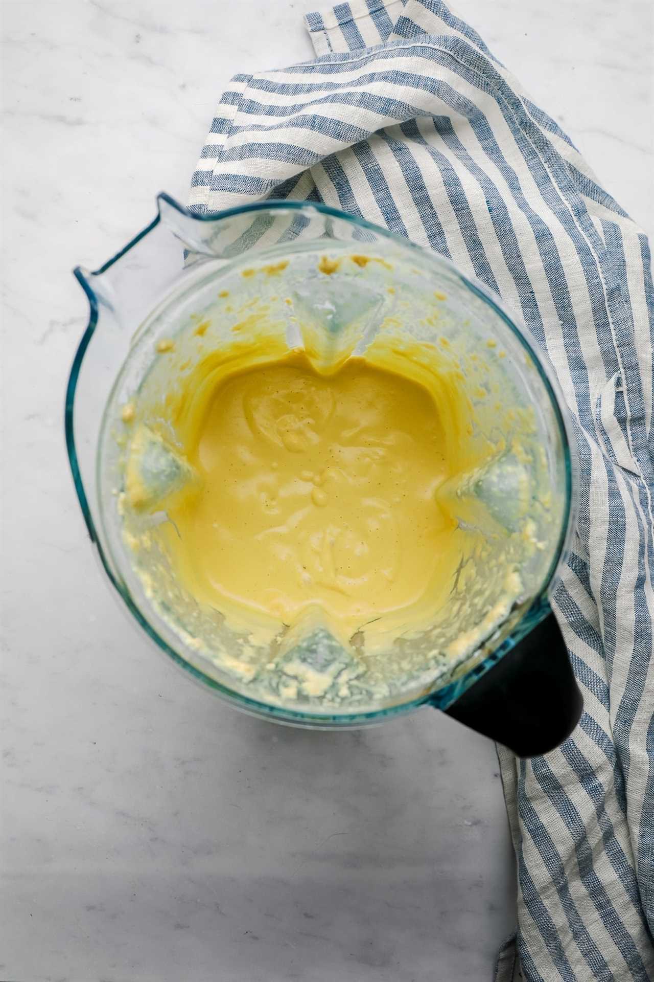 a creamy yellow salad dressing in a large blender.