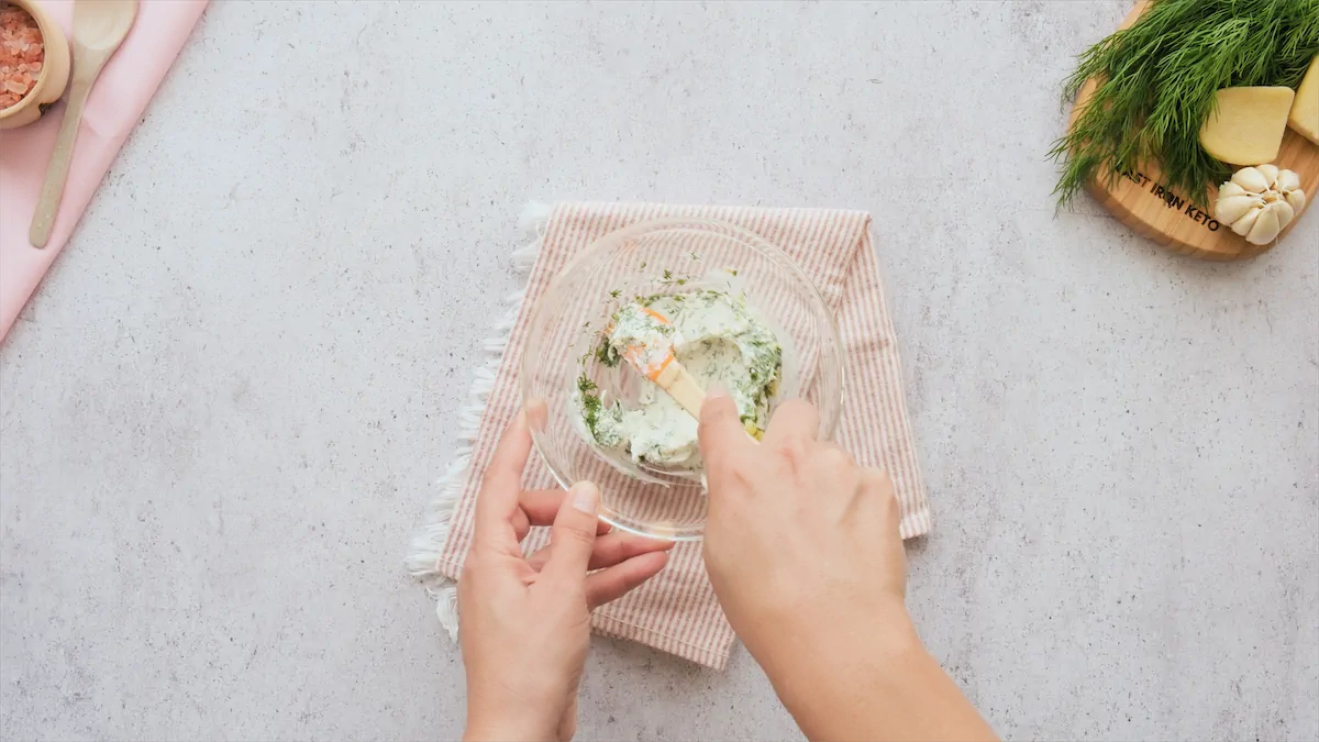 Mixing the labneh mixture in a mixing bowl.