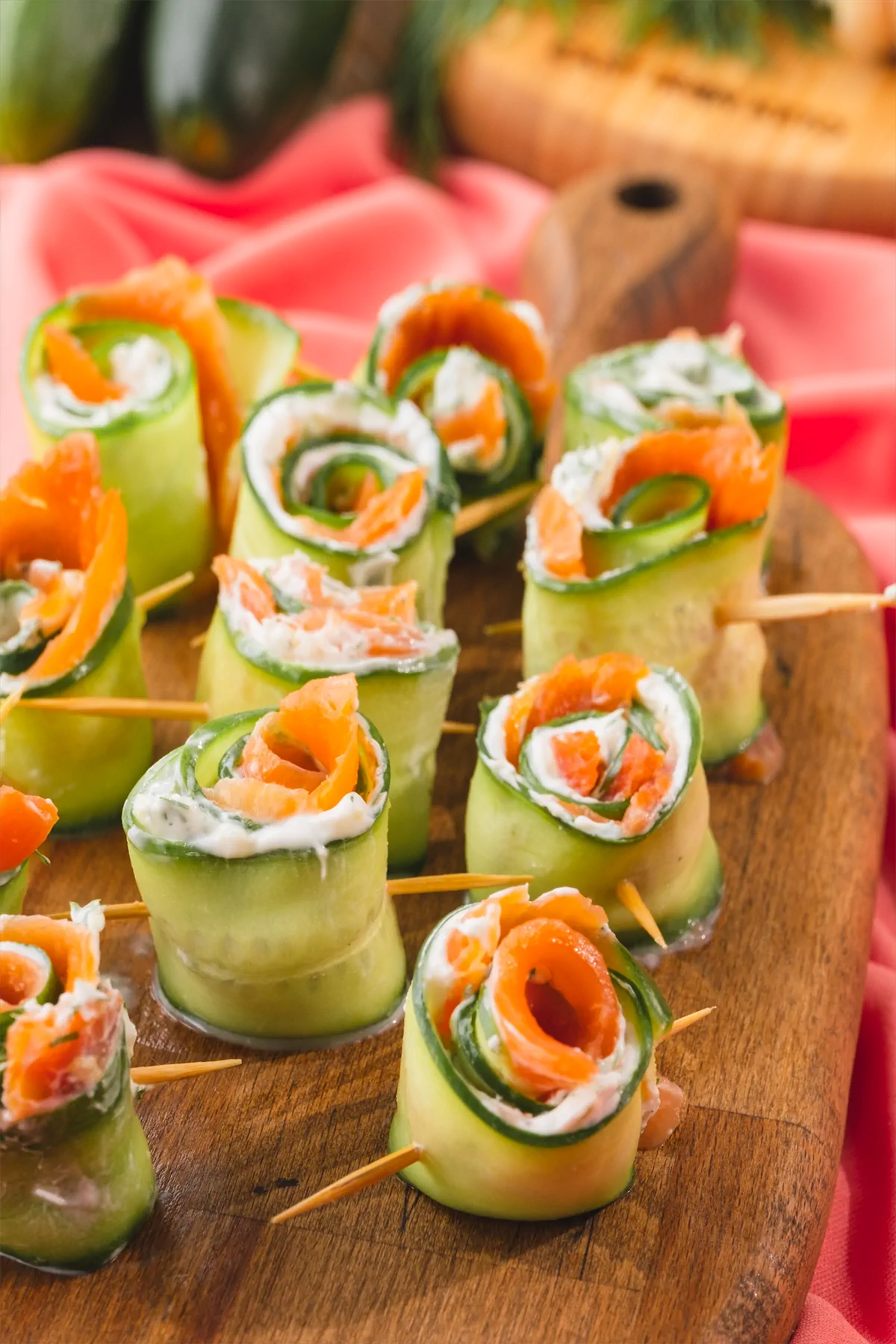 Keto salmon cucumber rolls pierced by toothpicks.