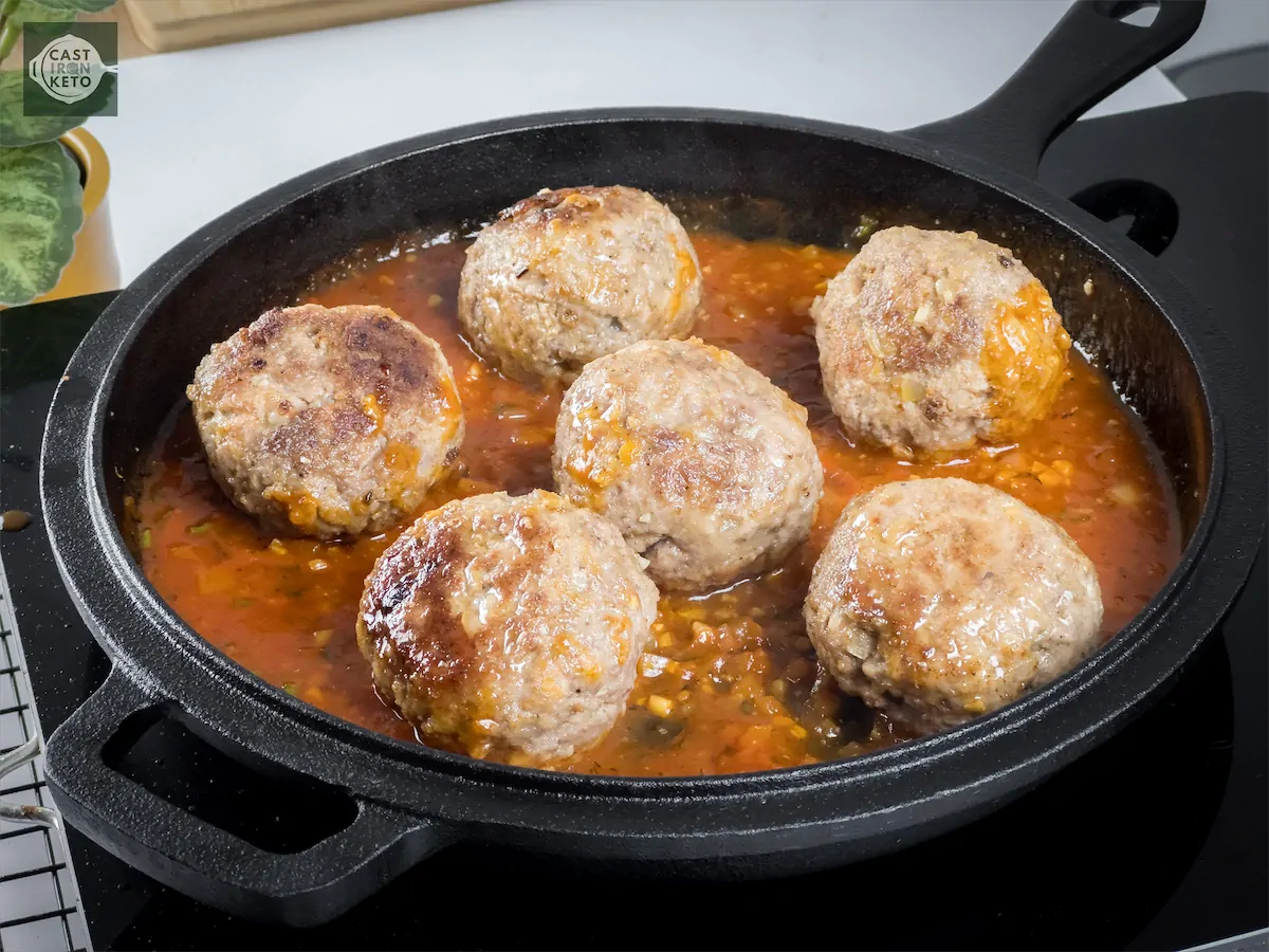 Cooking the meat balls in sauce.