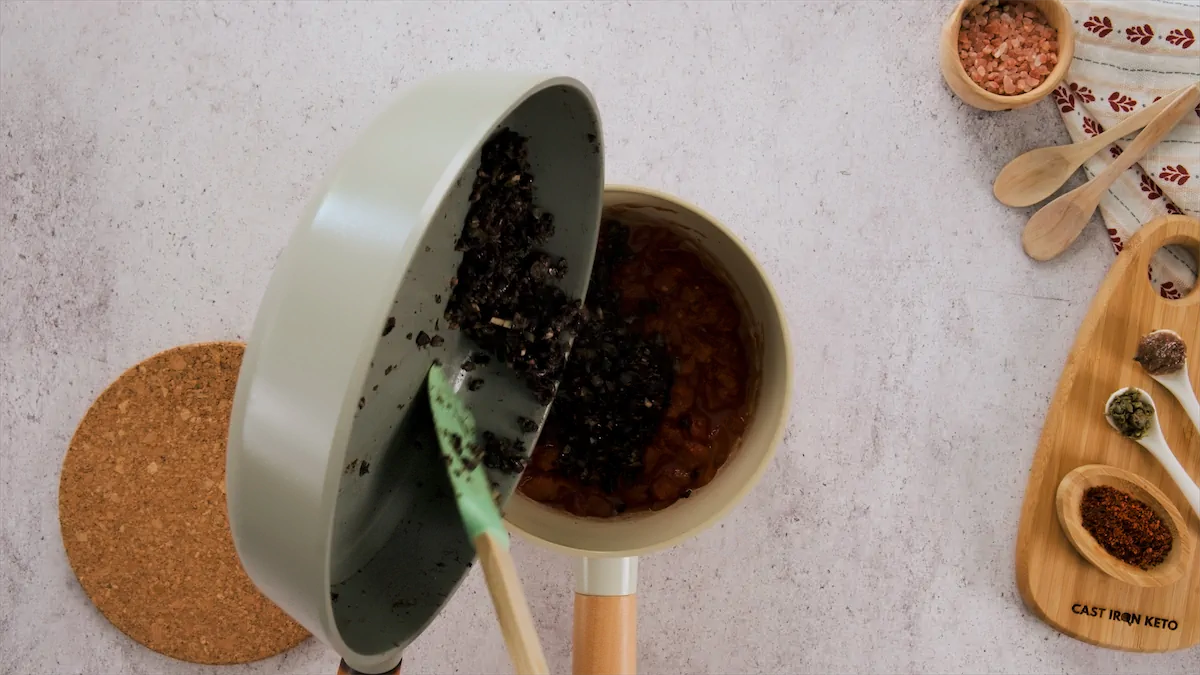 Adding the sautéed ingredients to a saucepan containing the mixture of chopped onions and dry white wine.