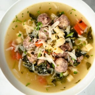 An close up over head shot of a bowl of italian wedding soup.