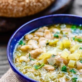 Easy Greek Bean Soup (Fasolada) | The Mediterranean Dish. Simple, flavor-packed Greek soup with white beans, celery, Mediterranean spices and aromatics. A satisfying weeknight dinner for a family on a budget! See the recipe on TheMediterraneanDish.com