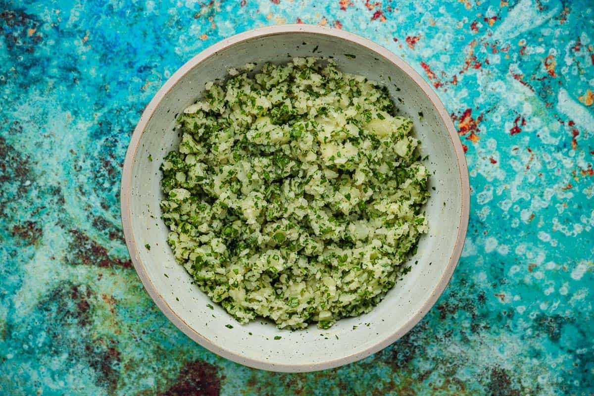 brik potato filling and chopped parsley mixed together in a bowl.