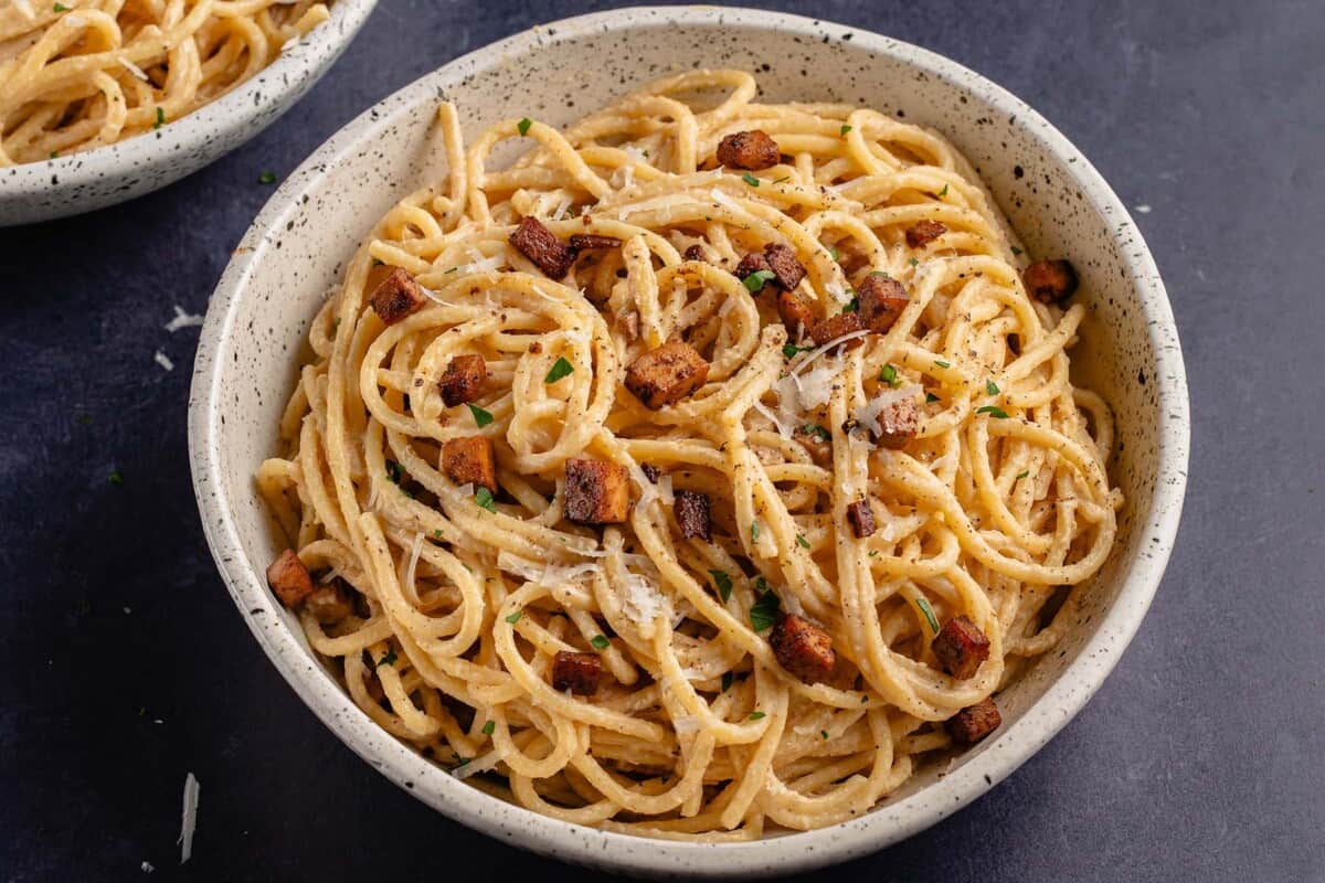 horizontal photo of Easy Vegan Carbonara in white bowl