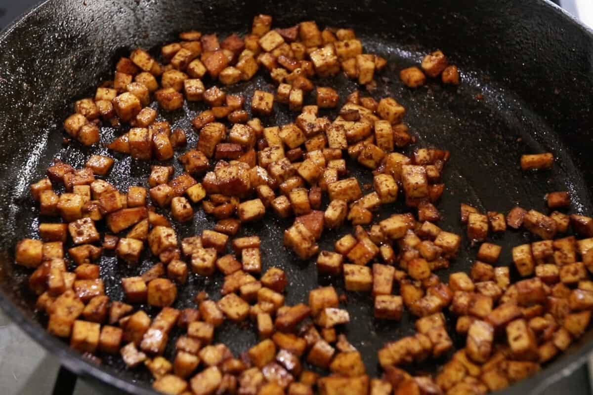 making tofu pancetta in cast iron skillet for carbonara