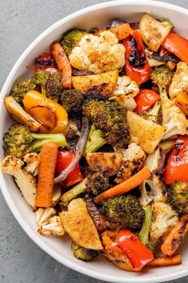 a close up of roasted vegetables in a white bowl