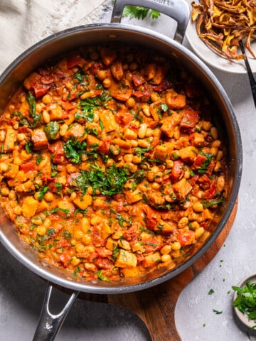 vegan sweet potato stew in a skillet on a tablescape.