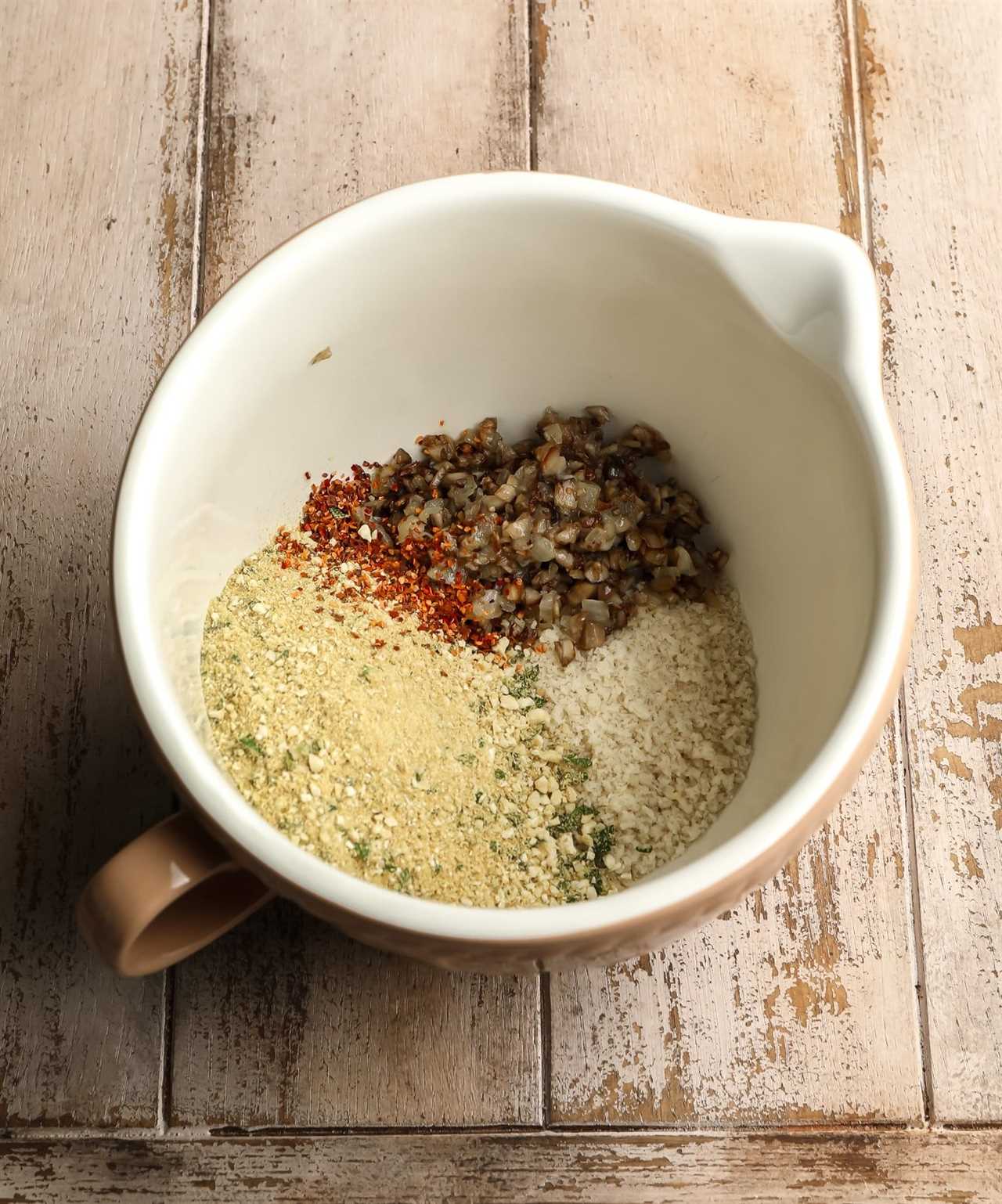 ingredients for stuffed mushroom filling in a white bowl.