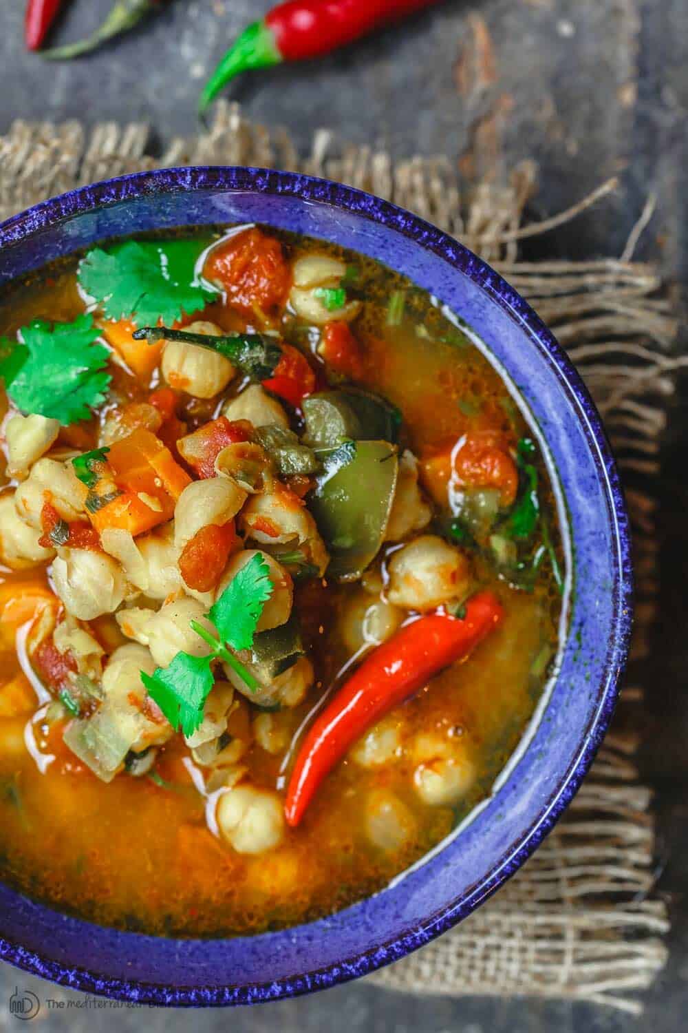 Easy Chickpea Instant Pot Soup | The Mediterranean Dish. Mediterranean style chickpea soup, with vegetables, fresh herbs, and great spices. You can make this in minutes in the Instant Pot, or see stovetop and slow cooker instructions. Great for make ahead and meal prep. #chickpeasoup #chickpearecipe #instantpotsoup #instantpotrecipe #instantpot #slowcooker #mediterraneandiet #veganrecipe #glutenfree #lowcarb