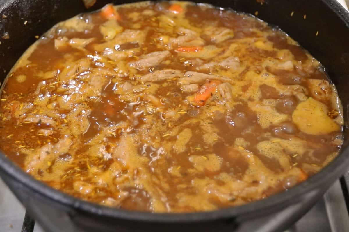 step by step - pot of vegan beef stew coming to a boil