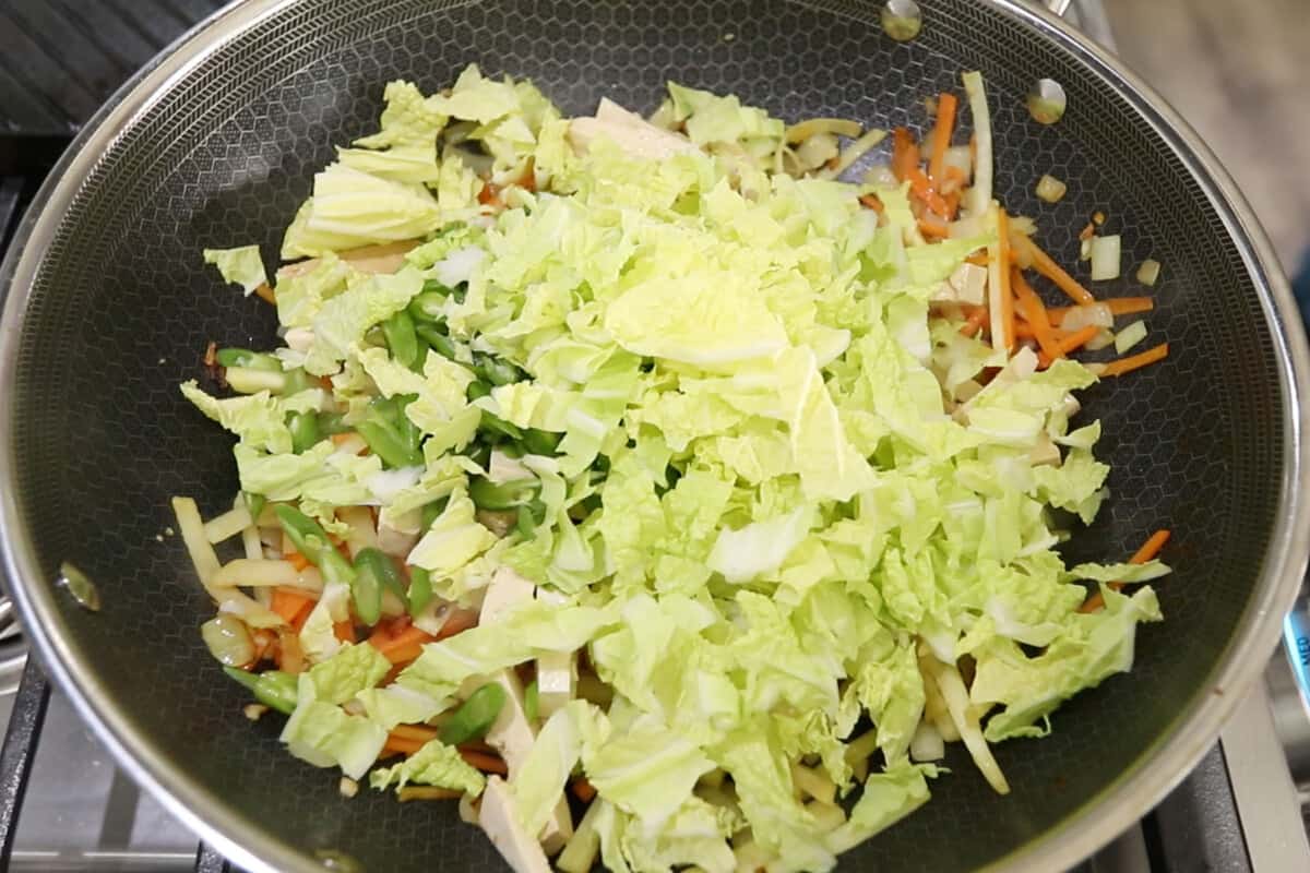 step by step - lettuce being added to the pan