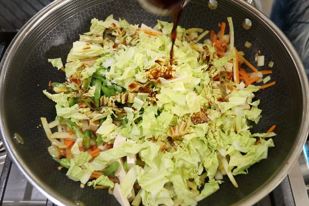 stap by step - soy sauce being added to the pan