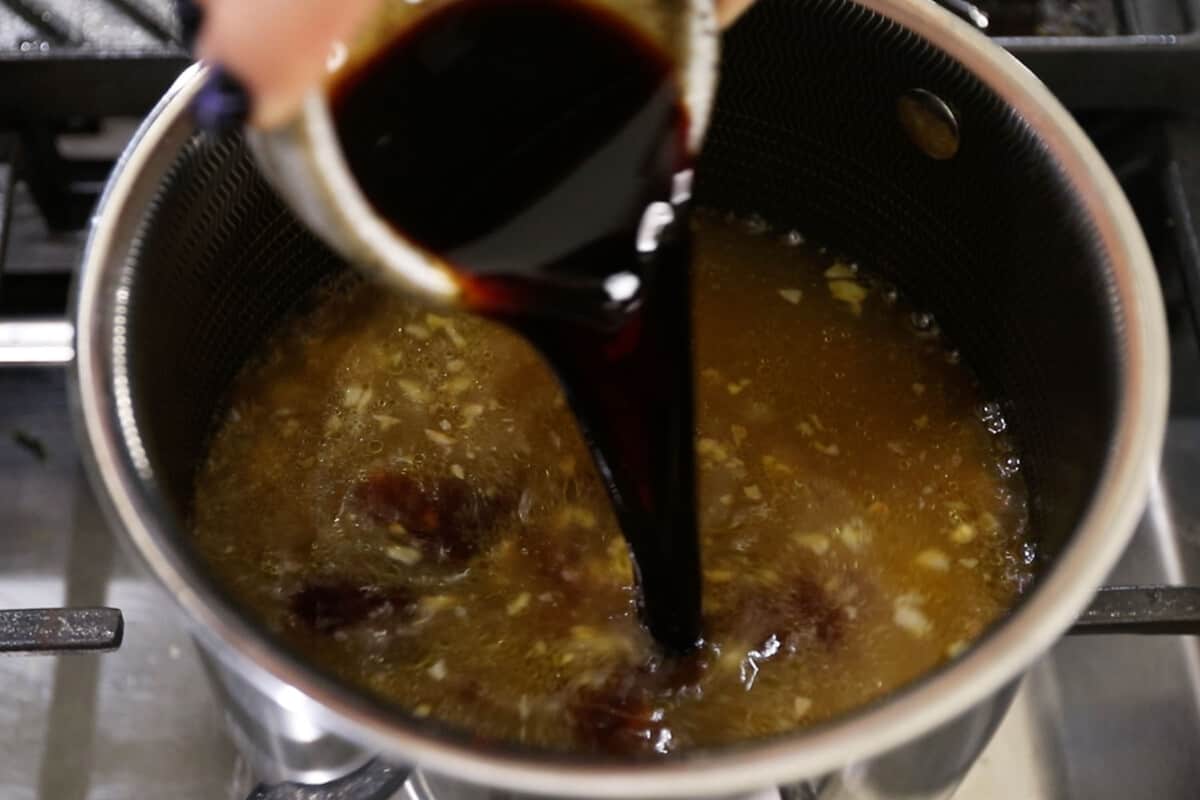 step by step - soy sauce being added to pot