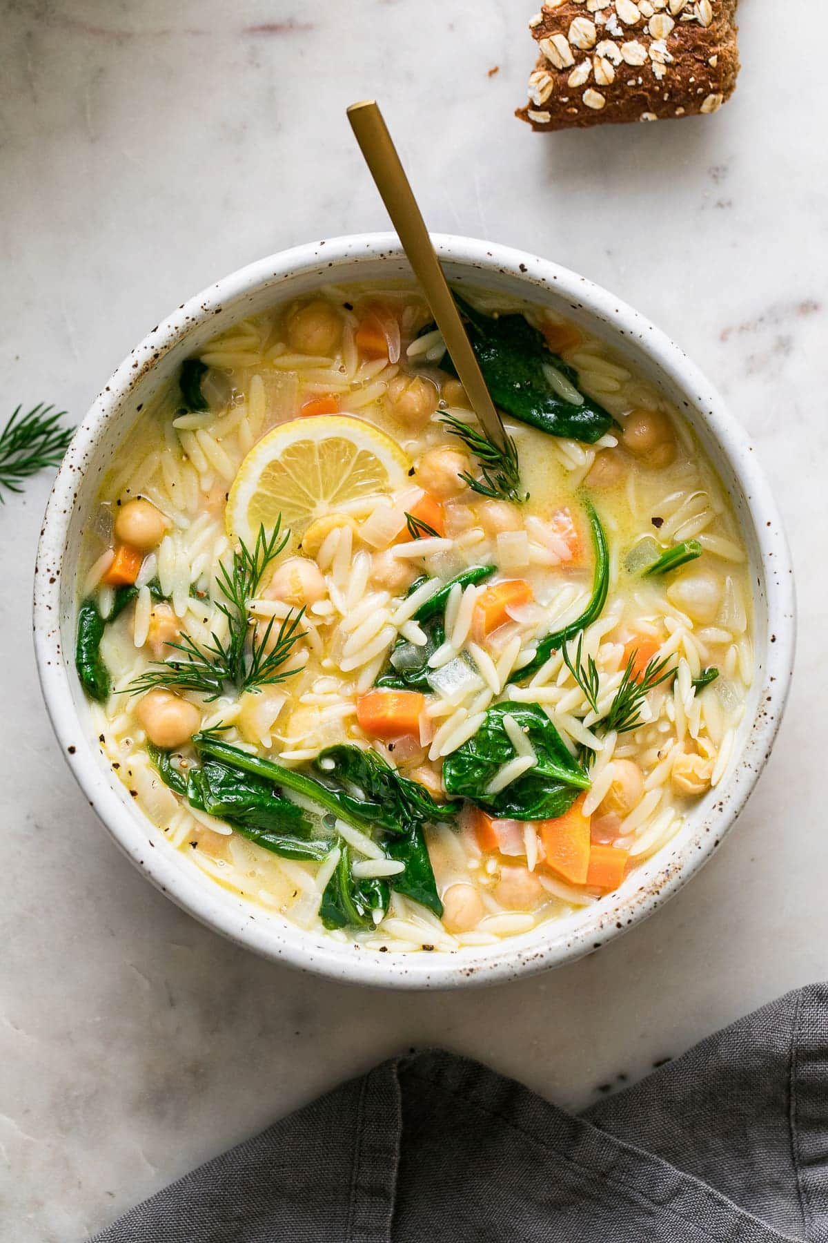 A bowl of vegan lemon chickpea orzo soup.