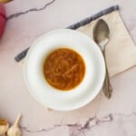 Keto French onion soup served in a bowl with a spoon.