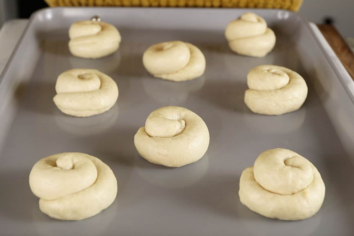 unbaked ensaymada on baking sheet