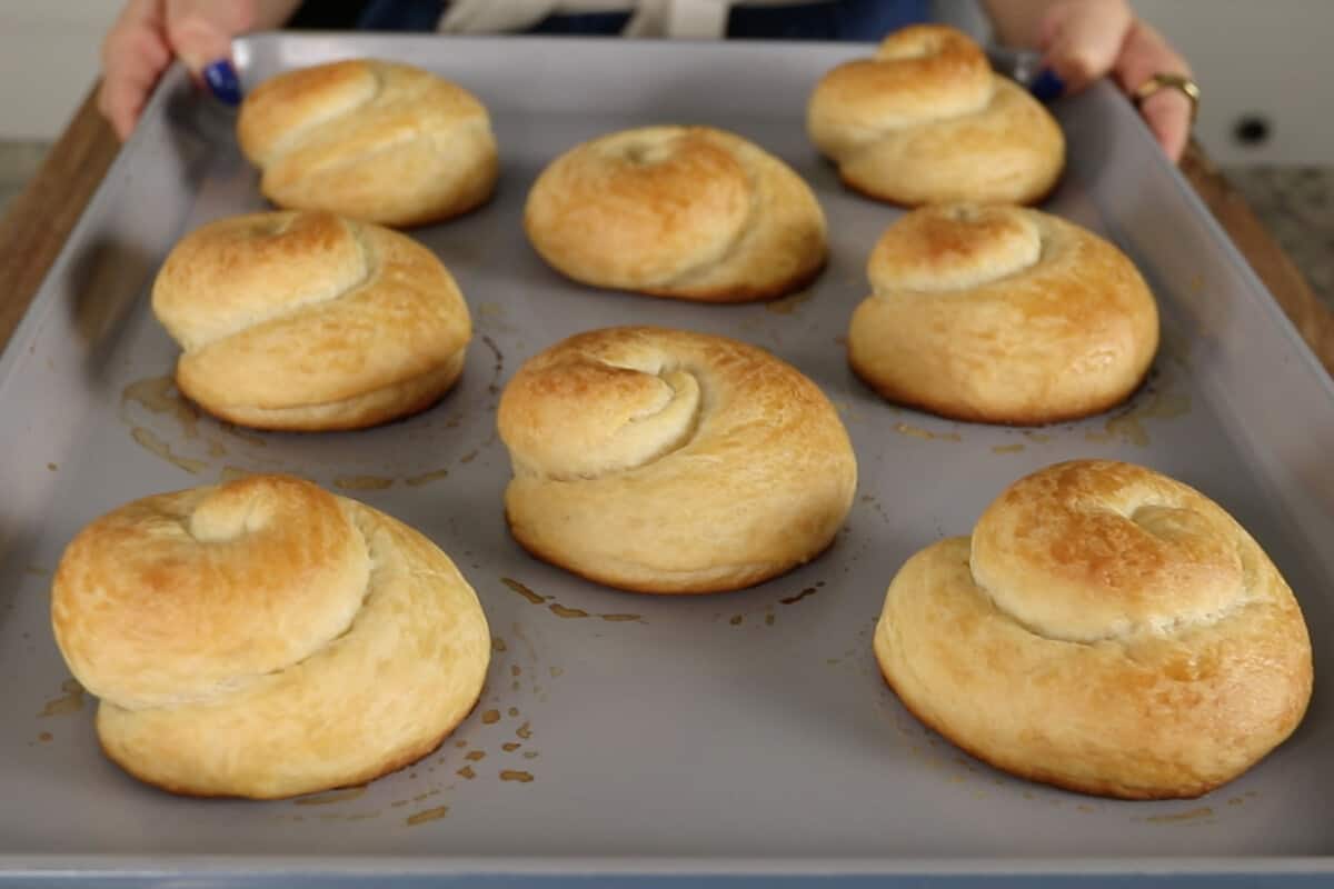 freshly baked ensaymada on baking sheet