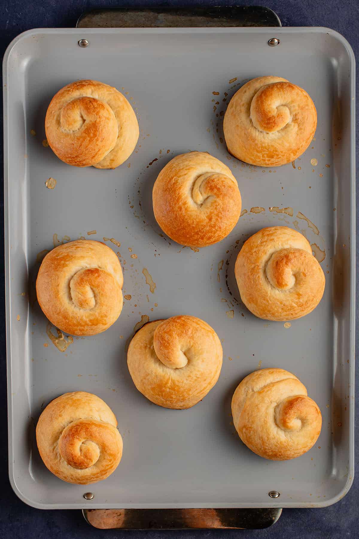 baked ensaymada on baking sheet