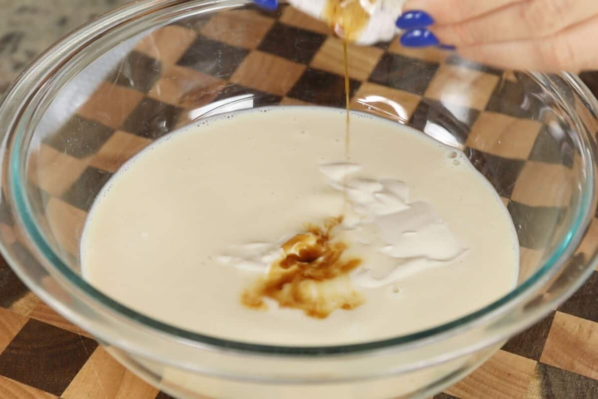 making vegan chia seed pudding with yogurt in large glass bowl