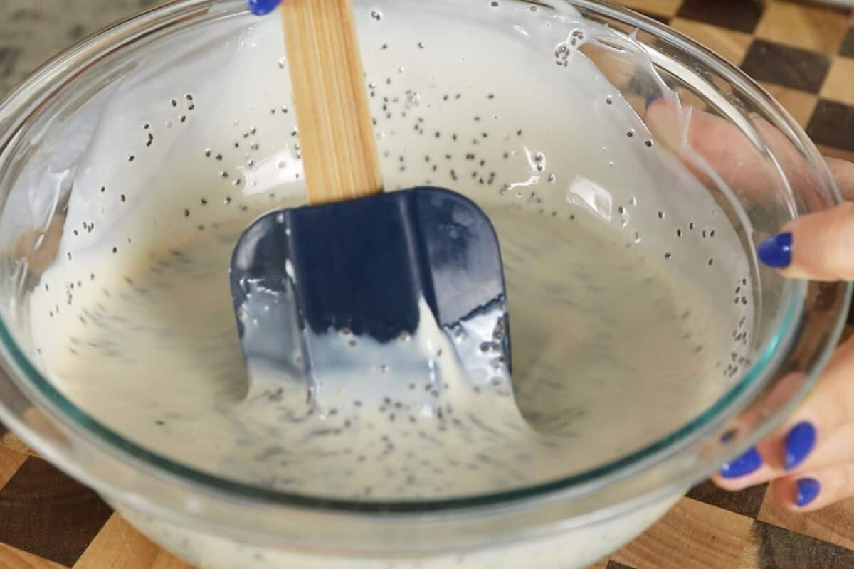 making vegan chia seed pudding with yogurt in large glass bowl