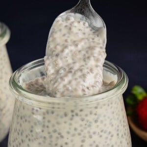 scooping Vegan Chia Pudding with Yogurt from glass jar with a spoon