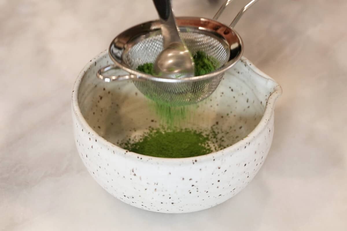 sifting matcha into matcha bowl