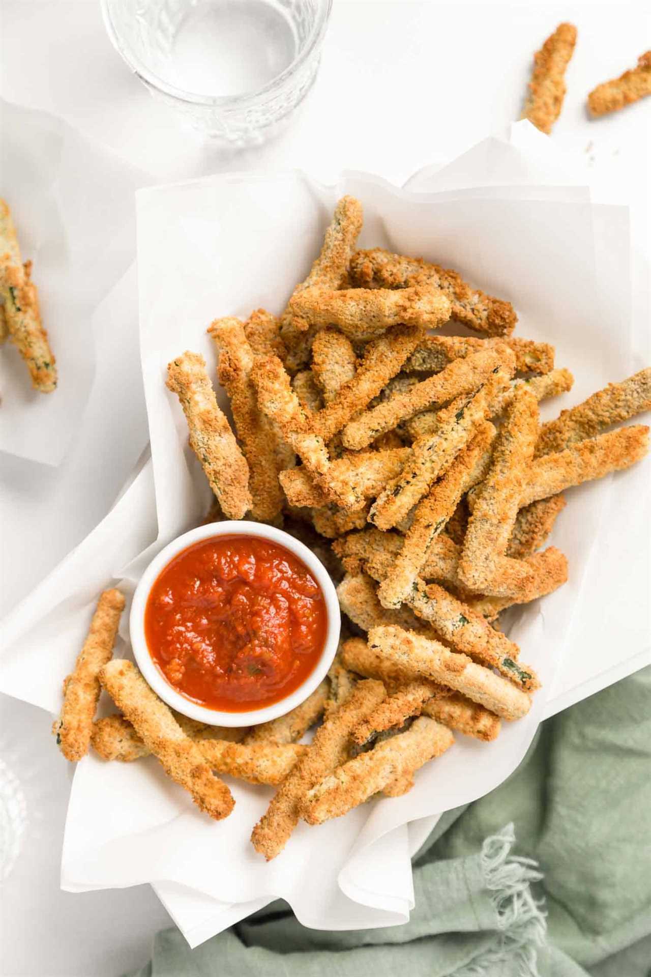 Basket of air fryer zucchini fries With Marinara Sauce Dip