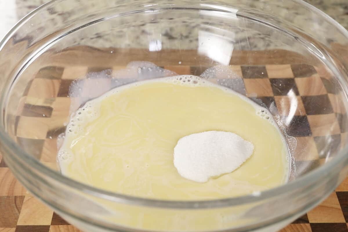 making fluffy ube brioche bread dough in large glass bowl