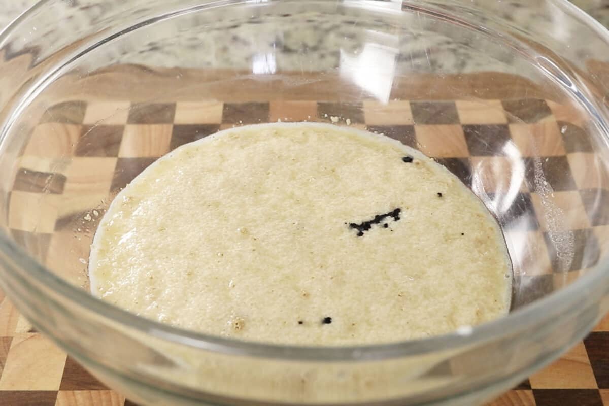 activating yeast for fluffy ube brioche bread dough in large glass bowl