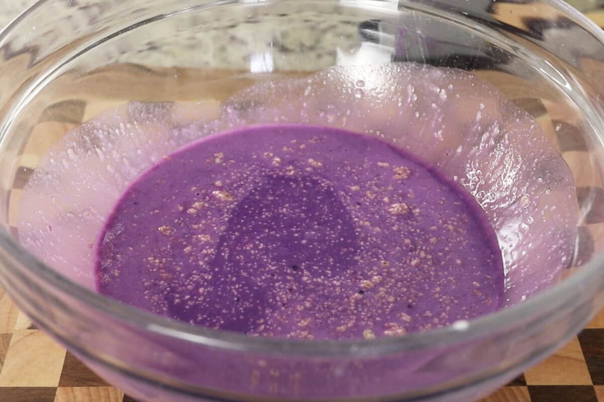 making fluffy ube brioche bread dough in large glass bowl