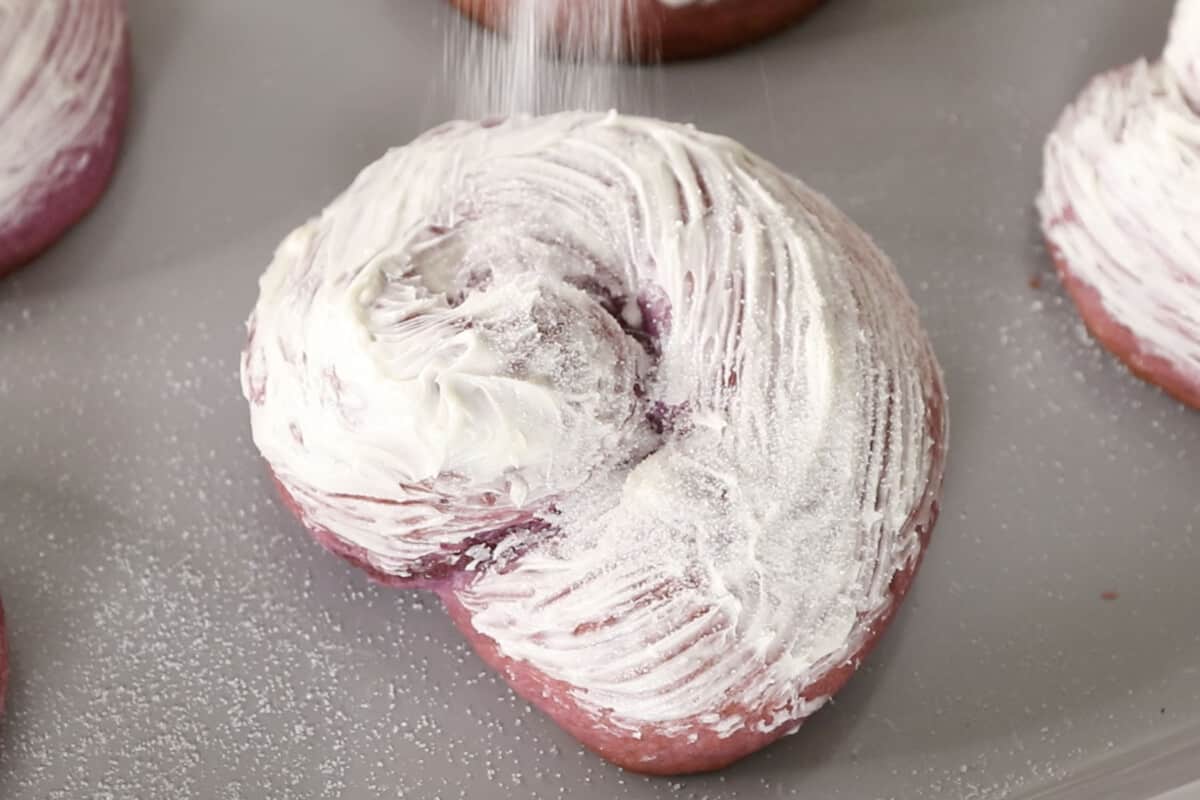 adding sugar to Filipino ube ensaymada brioche bread