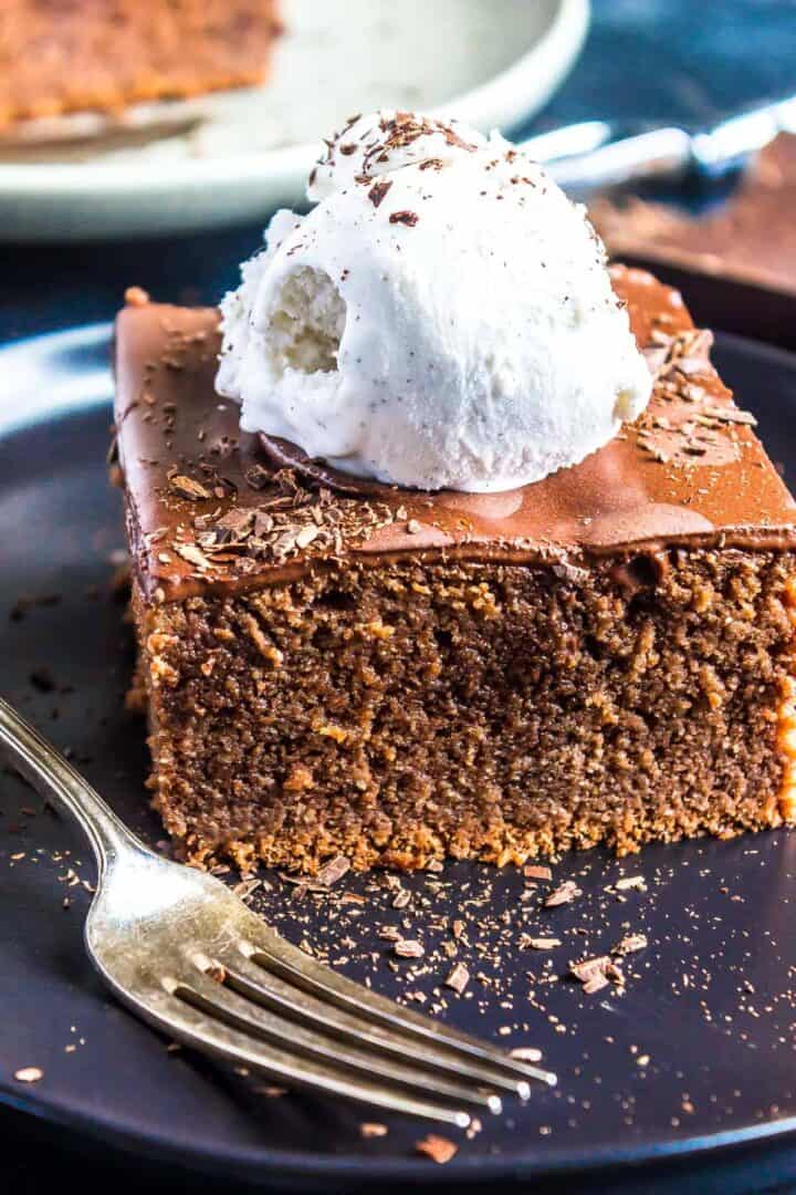 Keto Chocolate Pudding Poke Cake topped with whipped cream