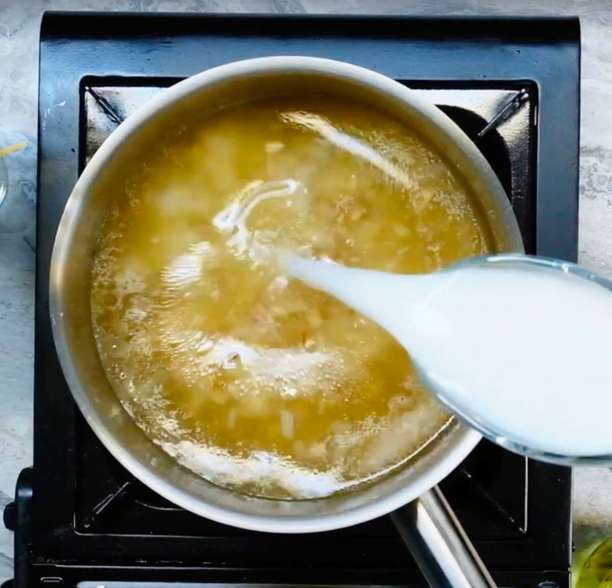 Broth and dairy-free milk added to the pot.