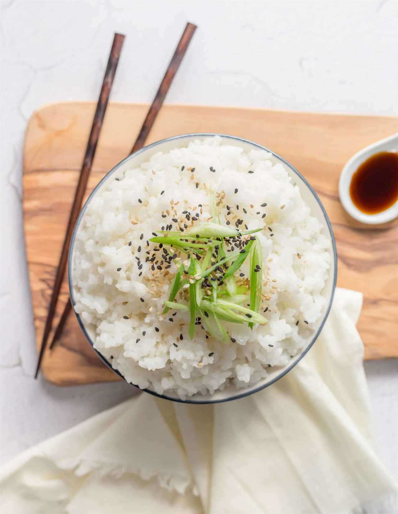 Steamed Sticky White Rice in a bowl with chopsticks. 