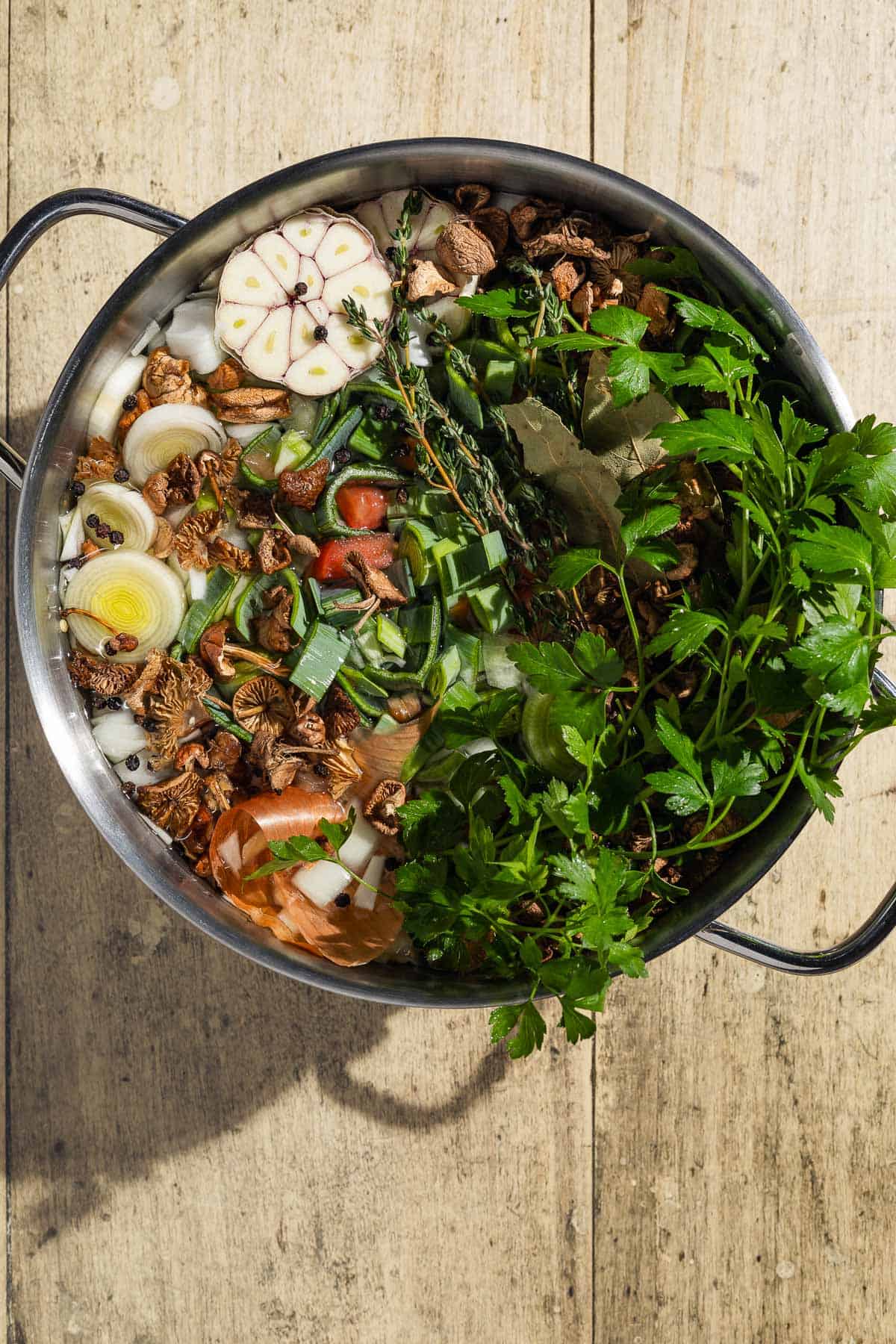 An overhead photo of all the ingredients for the homemade vegetable stock in a pot before the water is added.