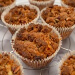 A close-up image of a keto almond flour muffin, surrounded by similar muffins, showcasing its texture.