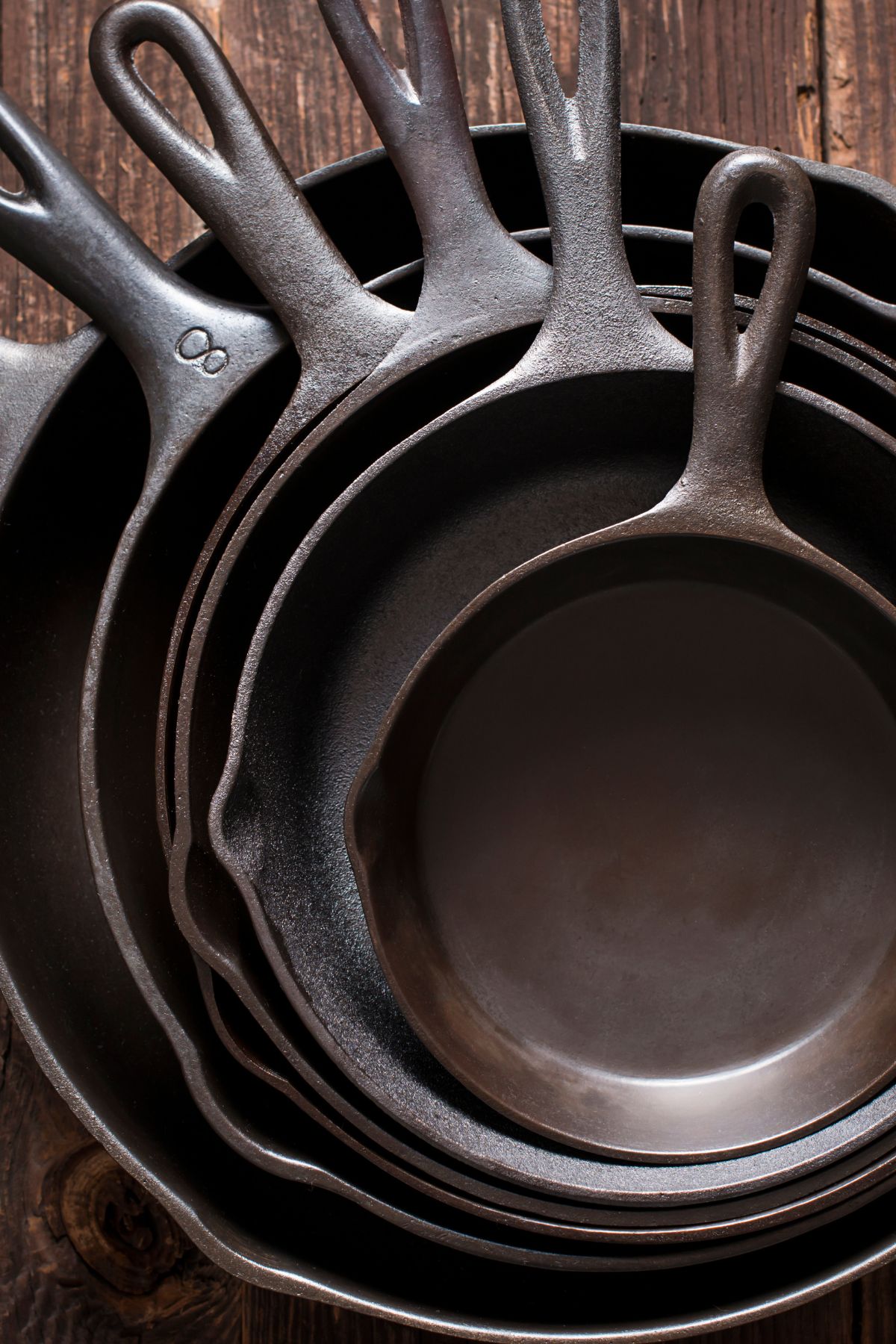 a set of 6 cast irons skillets nested inside each other.