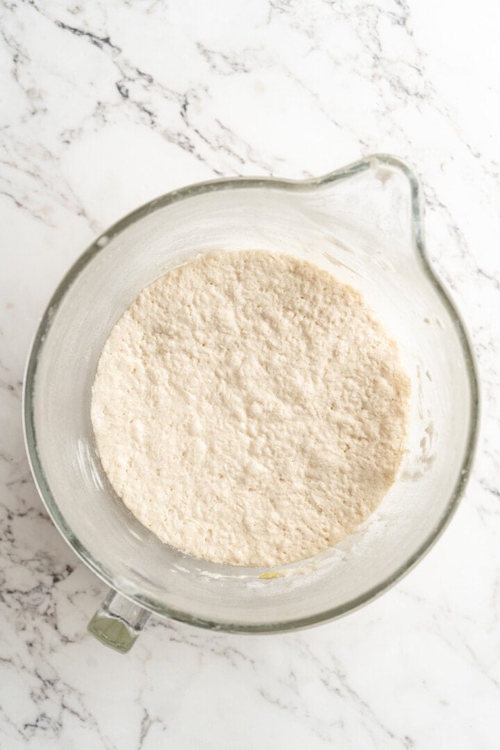 Dough for gluten-free focaccia in glass bowl