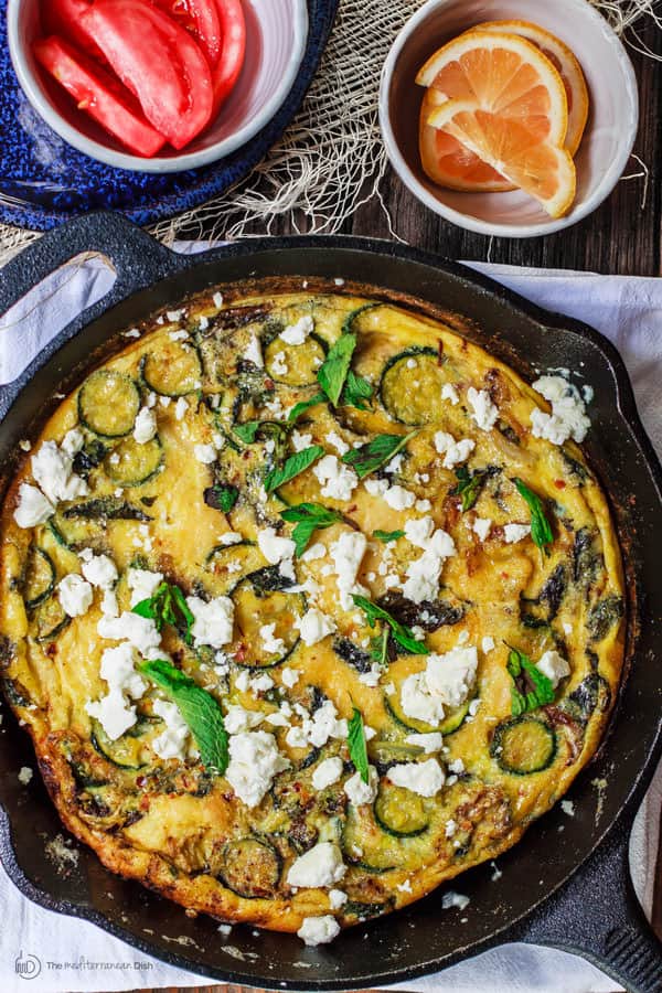 Middle Eastern Zuchini Baked Omelet Recipe | The Mediterranean Dish. A dense, flavor packed version of fritatta recipe. With zucchini, onions, fresh mint and olive oil. The perfect breakfast or brunch. See the step-by-step at The Mediterranean Dish!