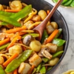 Pan of moo goo gai pan with wooden spoon