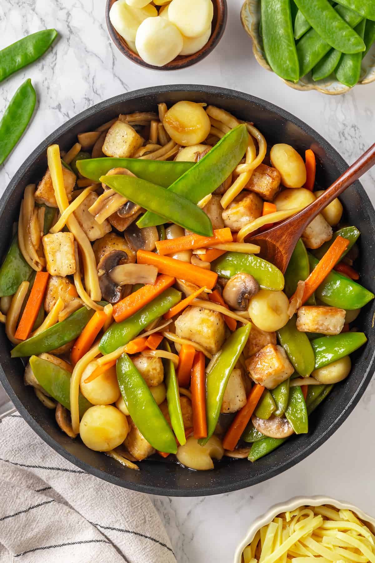 Overhead view of tofu moo goo gai pan in skillet