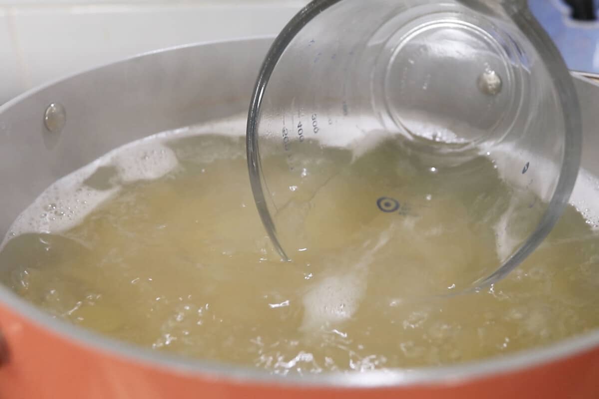 step by step: scooping water from the cooked pasta