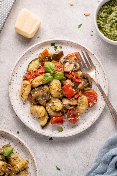 a white plate of vegan roasted pesto gnocchi